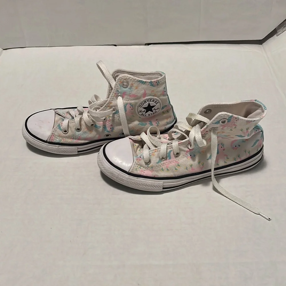 Converse unicorn high top tennis shoe.